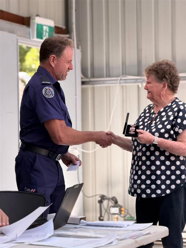 Sue Newnham receiving her award from Andrew Campbell